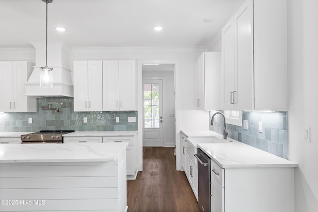 kitchen featuring white cabinets, stainless steel appliances, light stone countertops, and a sink