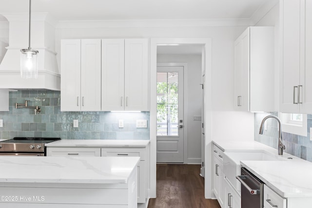 kitchen with white cabinets, appliances with stainless steel finishes, light stone counters, and dark wood finished floors