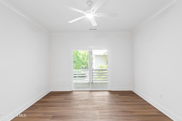 empty room with visible vents, ornamental molding, ceiling fan, and wood finished floors