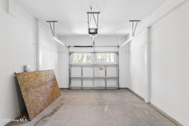 garage featuring baseboards and a garage door opener