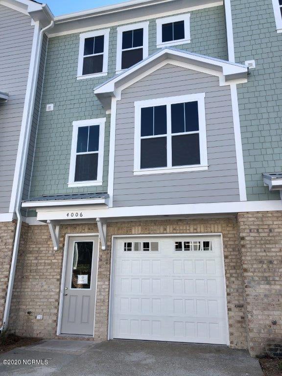 4006 Tamarisk Ln, Wilmington, NC 28409 - view of front of property with an attached garage, driveway, and brick siding