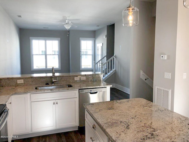 4006 Tamarisk Ln, Wilmington, NC 28409 - kitchen featuring visible vents, stainless steel dishwasher, light stone countertops, ceiling fan, and a sink