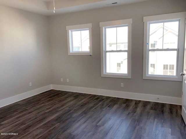 4006 Tamarisk Ln, Wilmington, NC 28409 - spare room featuring baseboards and dark wood finished floors