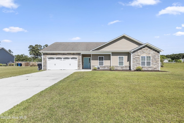 view of front of property featuring a garage, a front yard, stone siding, and concrete driveway