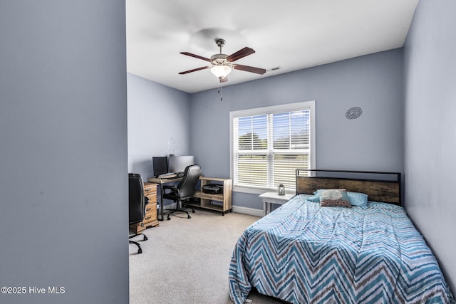 carpeted bedroom featuring baseboards, a ceiling fan, and visible vents