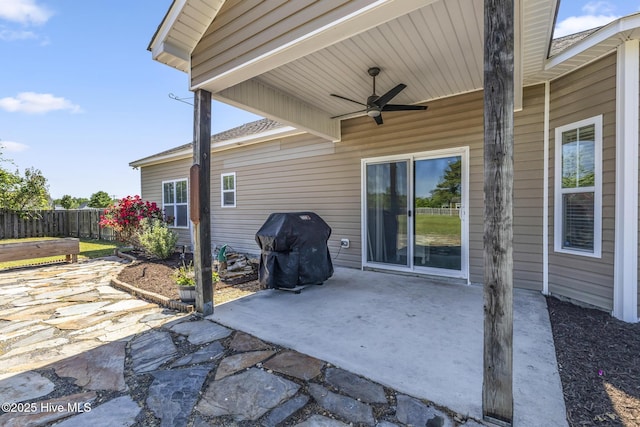 view of patio featuring grilling area, ceiling fan, and fence