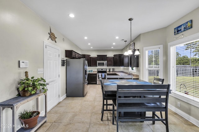 dining room with plenty of natural light, recessed lighting, and baseboards
