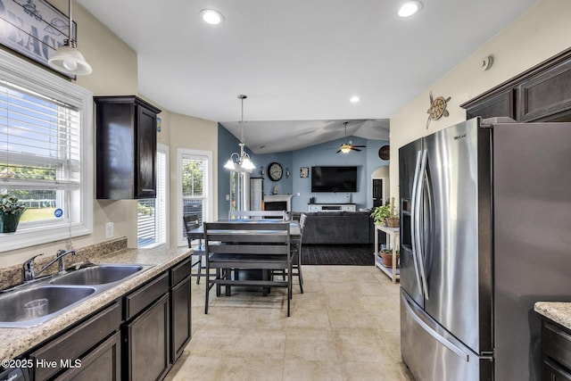 kitchen featuring dark brown cabinets, ceiling fan, a sink, open floor plan, and stainless steel refrigerator with ice dispenser