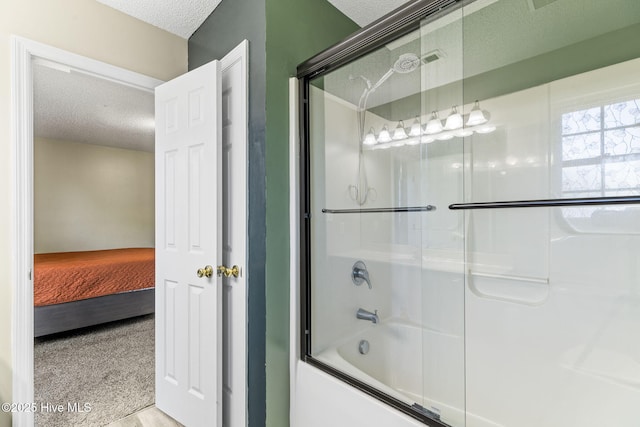 full bathroom with connected bathroom, shower / bath combination with glass door, and a textured ceiling