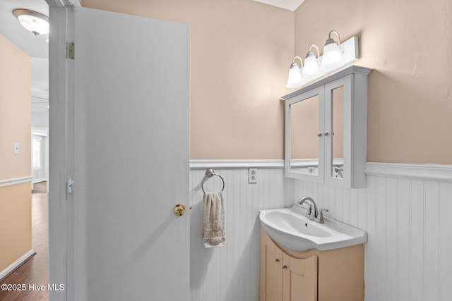 107 Palmetta Dr, Newport, NC 28570 - bathroom featuring wainscoting, wood finished floors, and vanity