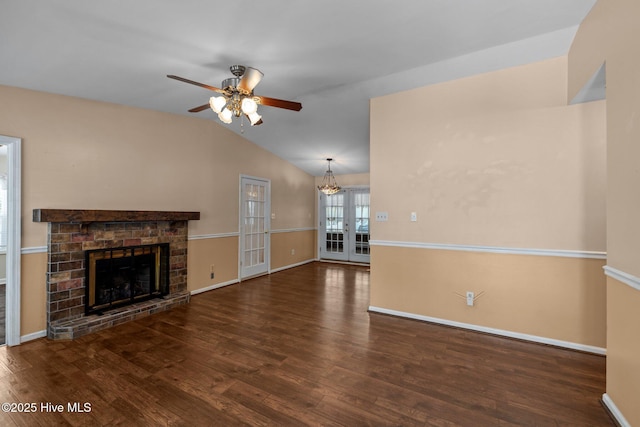 107 Palmetta Dr, Newport, NC 28570 - unfurnished living room featuring wood finished floors, lofted ceiling, baseboards, a fireplace with raised hearth, and ceiling fan with notable chandelier