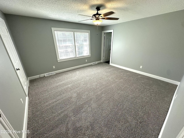 unfurnished bedroom featuring carpet flooring, a textured ceiling, and visible vents