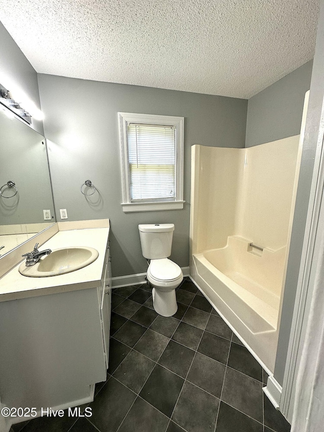 full bathroom featuring vanity, tile patterned floors, toilet, and a textured ceiling