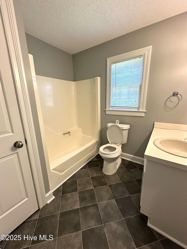 bathroom featuring vanity, toilet, tile patterned floors, a textured ceiling, and bathing tub / shower combination
