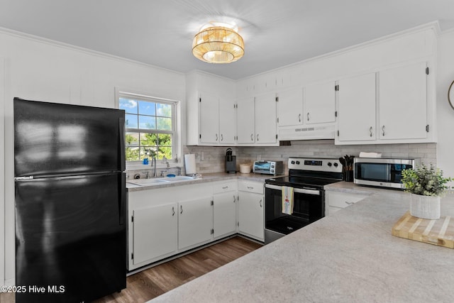 kitchen featuring dark wood-style flooring, a sink, light countertops, stainless steel appliances, and under cabinet range hood