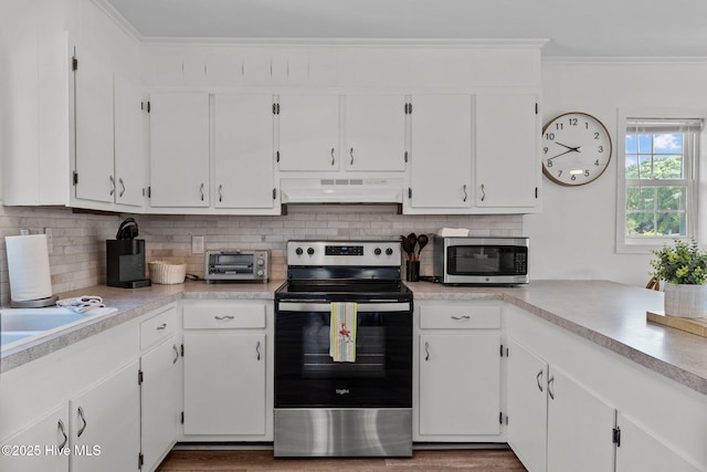 kitchen featuring under cabinet range hood, stainless steel appliances, and white cabinets