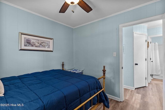 bedroom featuring crown molding, baseboards, ceiling fan, and wood finished floors