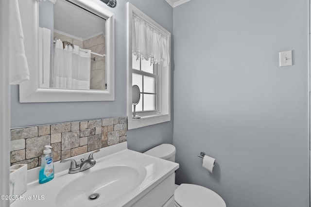 bathroom featuring vanity, ornamental molding, toilet, and a shower with curtain