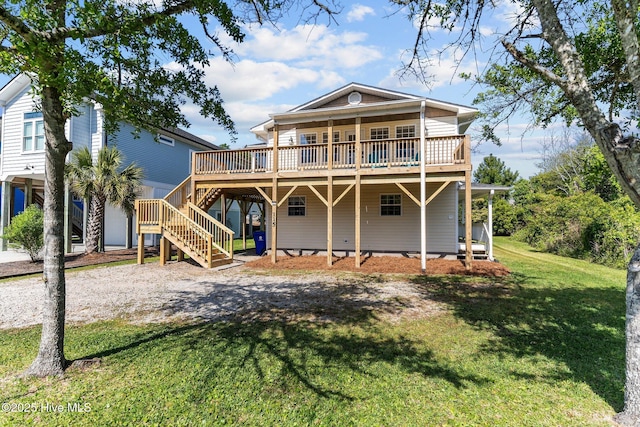 rear view of property featuring a lawn, a deck, and stairs
