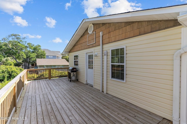 wooden deck featuring a grill