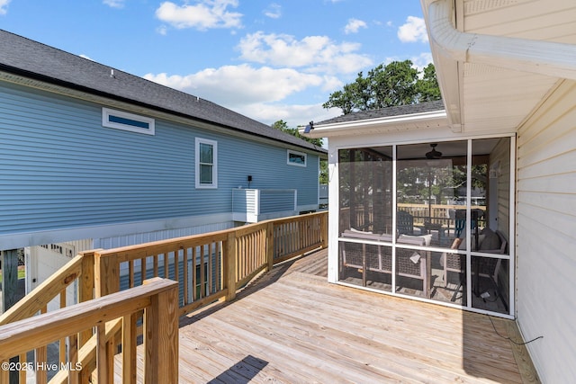 wooden deck with a sunroom