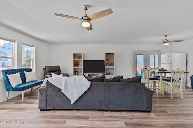 living room featuring ceiling fan and light wood-style flooring