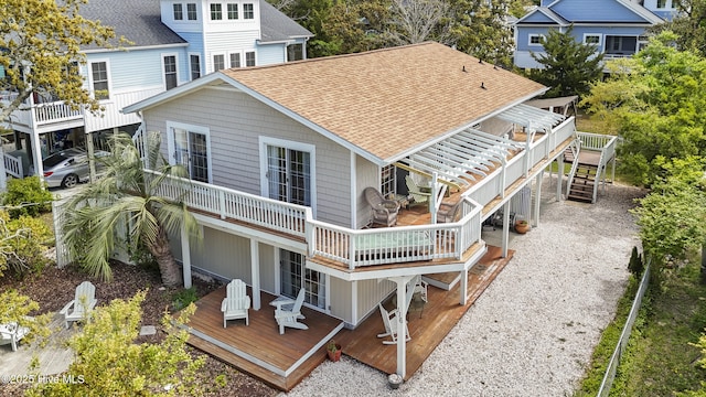 116 SE 8th St, Oak Island, NC 28465 - back of property featuring roof with shingles, a wooden deck, and stairs