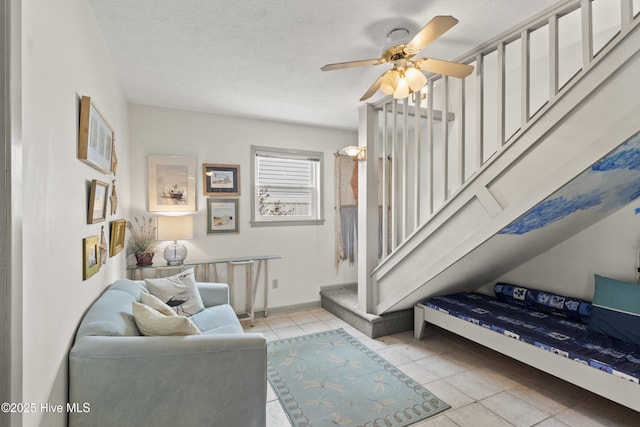 116 SE 8th St, Oak Island, NC 28465 - living room featuring a ceiling fan, stairs, baseboards, and light tile patterned floors