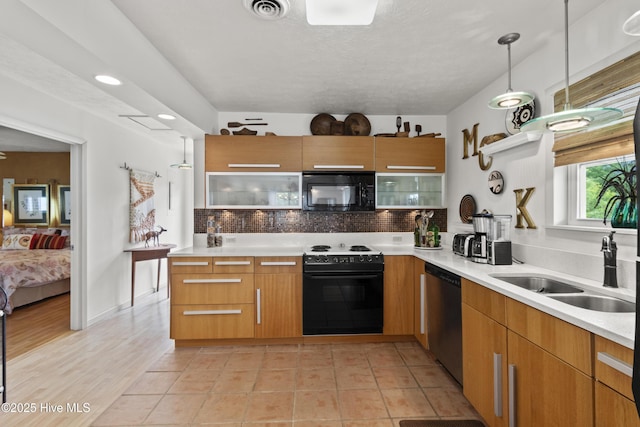 116 SE 8th St, Oak Island, NC 28465 - kitchen featuring decorative backsplash, visible vents, modern cabinets, and black appliances