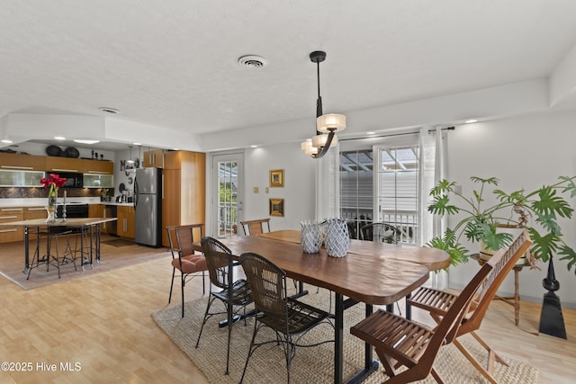 116 SE 8th St, Oak Island, NC 28465 - dining space featuring light wood finished floors and visible vents