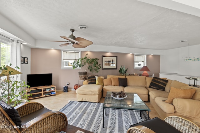 116 SE 8th St, Oak Island, NC 28465 - living area with wood finished floors, a ceiling fan, plenty of natural light, and visible vents