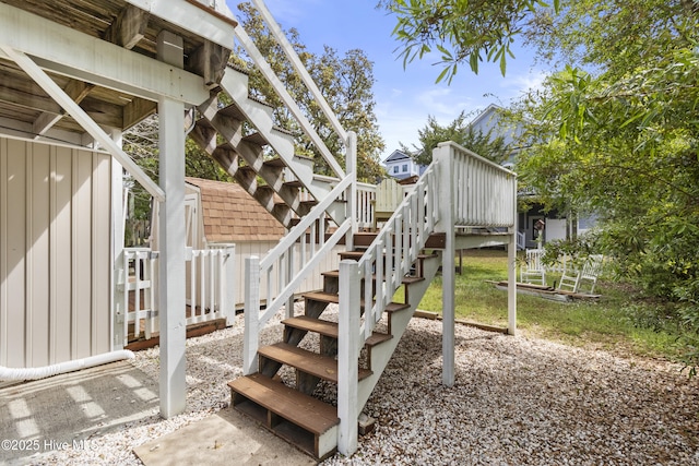 116 SE 8th St, Oak Island, NC 28465 - exterior space featuring stairway, a wooden deck, and a storage shed