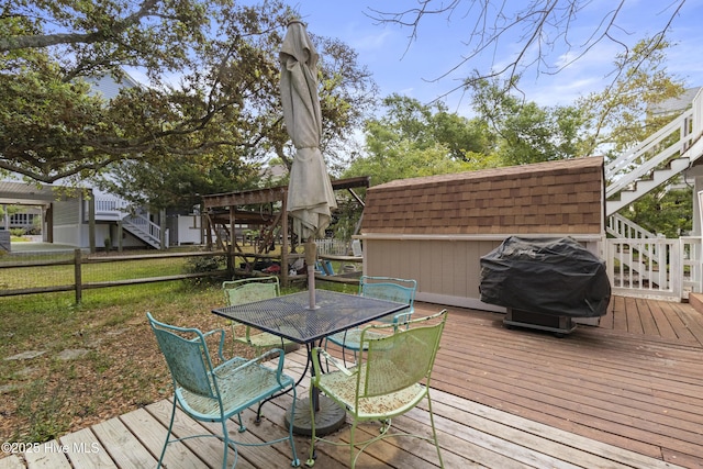 116 SE 8th St, Oak Island, NC 28465 - deck with fence, stairway, a grill, and outdoor dining space