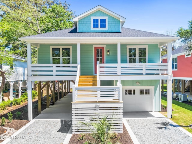 322 NE 50th St, Oak Island, NC 28465 - beach home featuring a porch, driveway, roof with shingles, a garage, and cooling unit