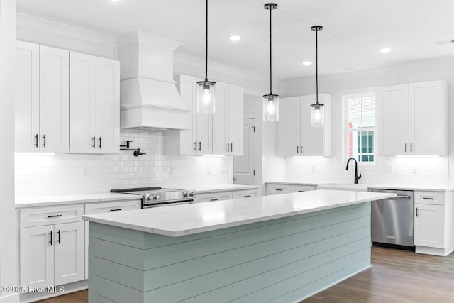 322 NE 50th St, Oak Island, NC 28465 - kitchen featuring a sink, stainless steel appliances, white cabinetry, tasteful backsplash, and ornamental molding