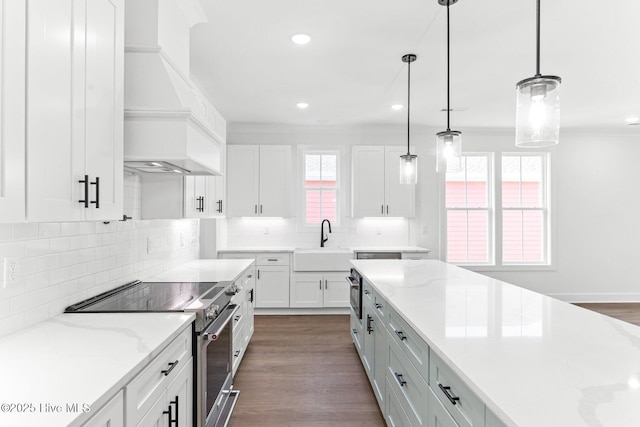 322 NE 50th St, Oak Island, NC 28465 - kitchen featuring stainless steel electric range, a sink, premium range hood, ornamental molding, and white cabinetry