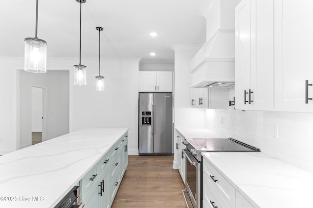 322 NE 50th St, Oak Island, NC 28465 - kitchen with appliances with stainless steel finishes, premium range hood, light wood-type flooring, and white cabinetry