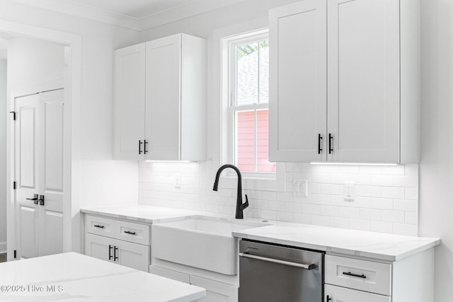 322 NE 50th St, Oak Island, NC 28465 - kitchen featuring light stone countertops, a sink, white cabinetry, decorative backsplash, and stainless steel dishwasher