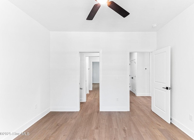 322 NE 50th St, Oak Island, NC 28465 - unfurnished bedroom with a ceiling fan, baseboards, and light wood-type flooring