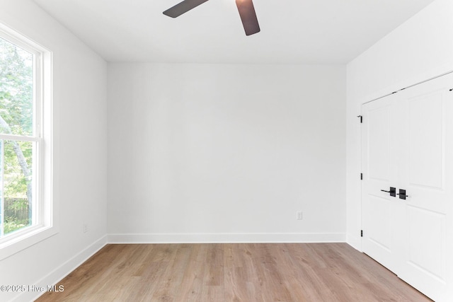 322 NE 50th St, Oak Island, NC 28465 - spare room featuring baseboards, ceiling fan, a healthy amount of sunlight, and light wood-style flooring