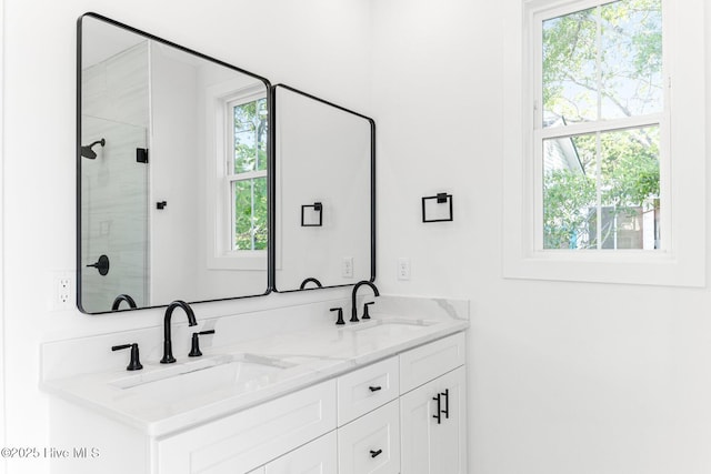 322 NE 50th St, Oak Island, NC 28465 - bathroom with double vanity, a sink, and a stall shower