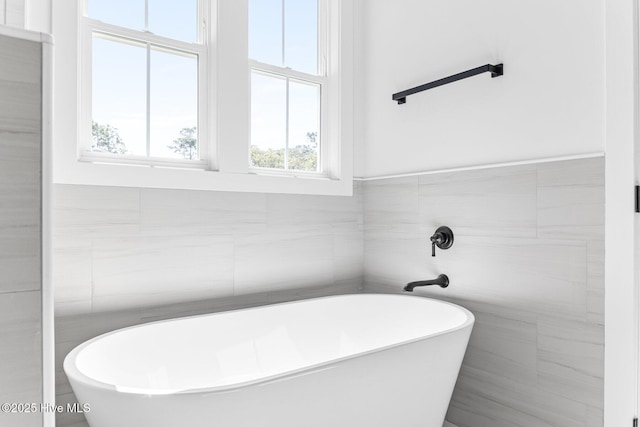 322 NE 50th St, Oak Island, NC 28465 - bathroom with a freestanding tub and tile walls
