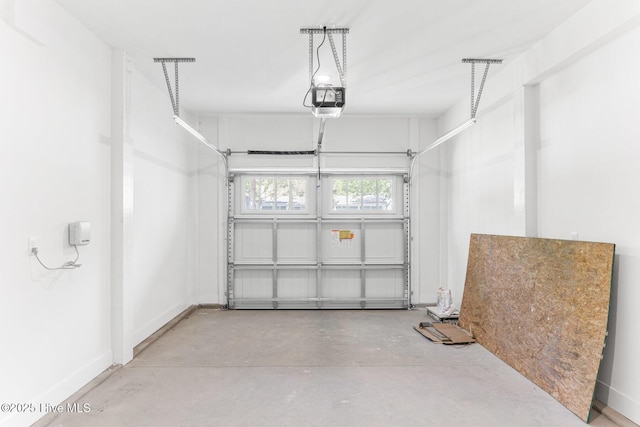 322 NE 50th St, Oak Island, NC 28465 - garage with baseboards and a garage door opener