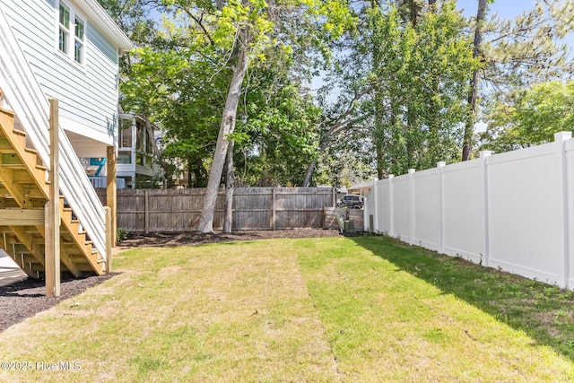 322 NE 50th St, Oak Island, NC 28465 - view of yard featuring a fenced backyard and stairs