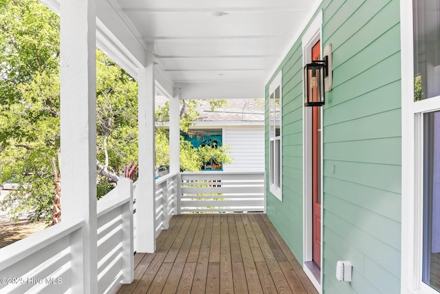 322 NE 50th St, Oak Island, NC 28465 - wooden deck featuring covered porch