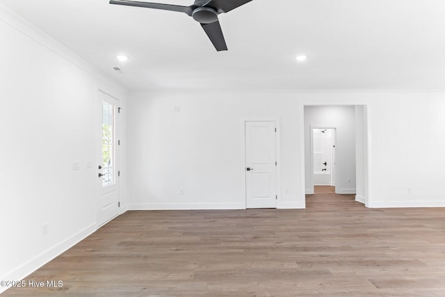 322 NE 50th St, Oak Island, NC 28465 - unfurnished room featuring crown molding, a ceiling fan, baseboards, and light wood-style floors