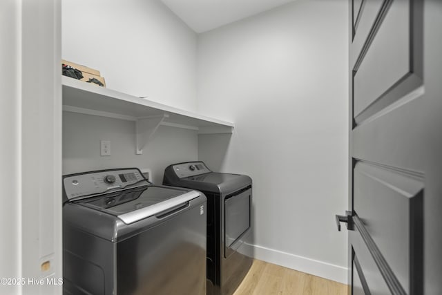 149 Pelican Pointe Dr, Elizabeth City, NC 27909 - clothes washing area with baseboards, laundry area, washing machine and dryer, and light wood finished floors