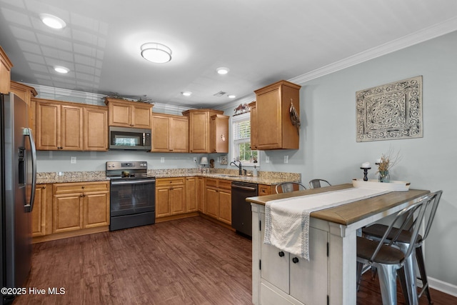 kitchen featuring crown molding, a sink, appliances with stainless steel finishes, and light stone counters