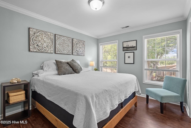 bedroom featuring baseboards, dark wood finished floors, ornamental molding, and visible vents