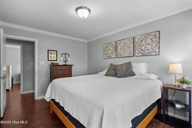 bedroom with baseboards, ornamental molding, and wood finished floors